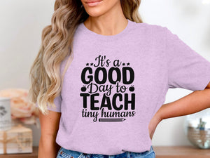 Light pink t-shirt with black text that reads, "It's a GOOD Day to TEACH tiny humans."