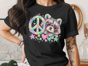 Black t-shirt with a colorful raccoon wearing heart sunglasses and a peace sign.