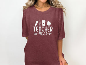 Maroon t-shirt with "Teacher Vibes" text and school icons in white.