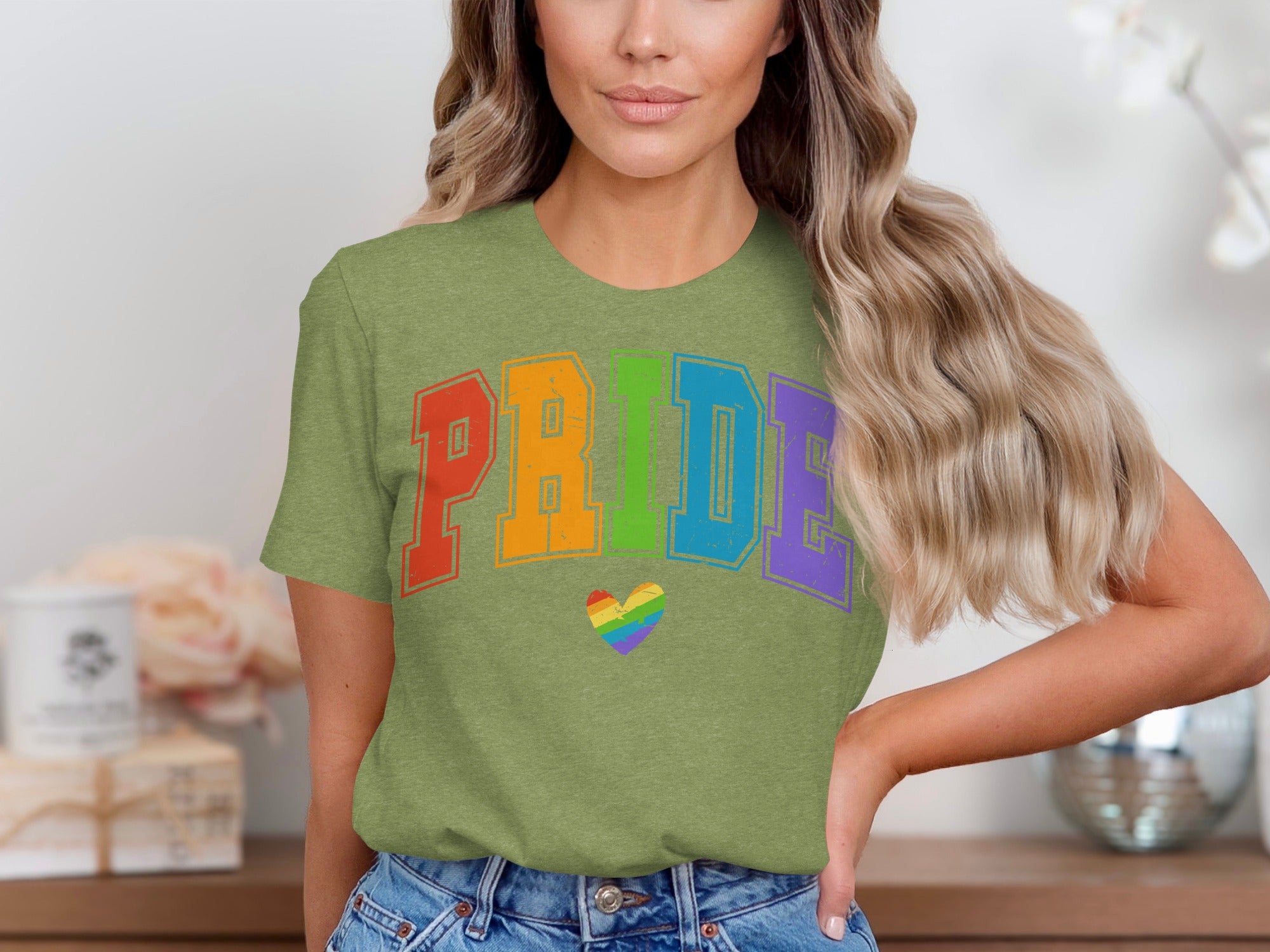 Green t-shirt with colorful "PRIDE" text and a rainbow heart graphic.