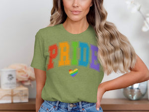 Green t-shirt with colorful "PRIDE" text and a rainbow heart graphic.