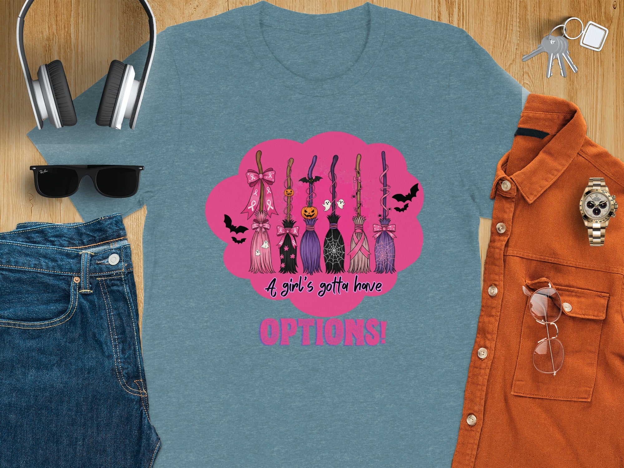 Blue t-shirt with Halloween brooms and pink lettering saying "A girl's gotta have OPTIONS!".
