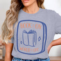 Gray t-shirt with "BOOK: ON WORLD: OFF" text and an open book graphic.