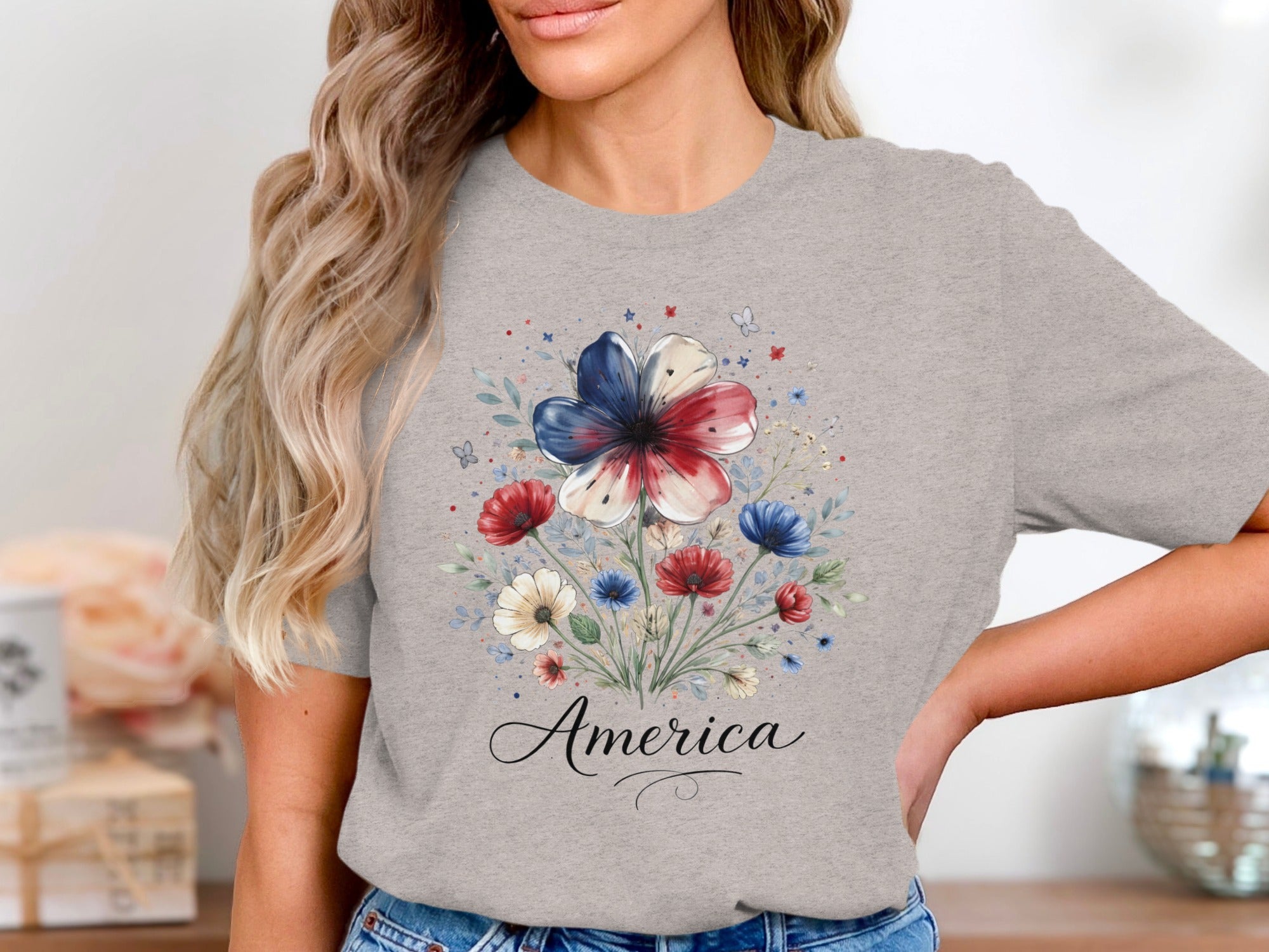 Gray t-shirt with a floral print featuring red, white, and blue flowers and the word "America".