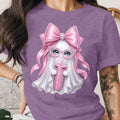 Ghost with pink bow, glasses, and rhinestone cup on a purple t-shirt.