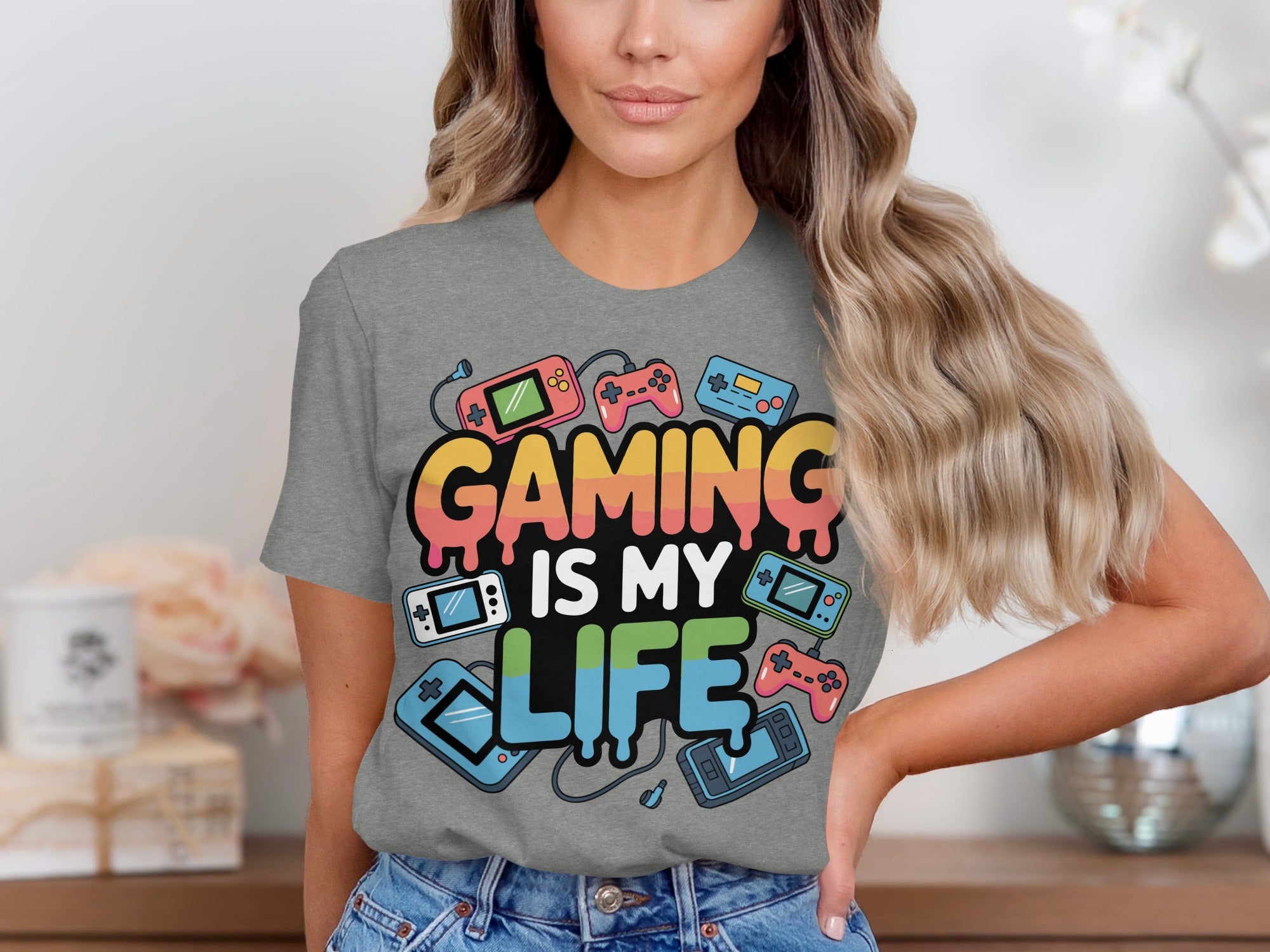 Grey t-shirt with "GAMING IS MY LIFE" text and retro gaming icons.