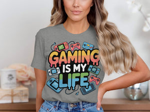 Grey t-shirt with "GAMING IS MY LIFE" text and retro gaming icons.