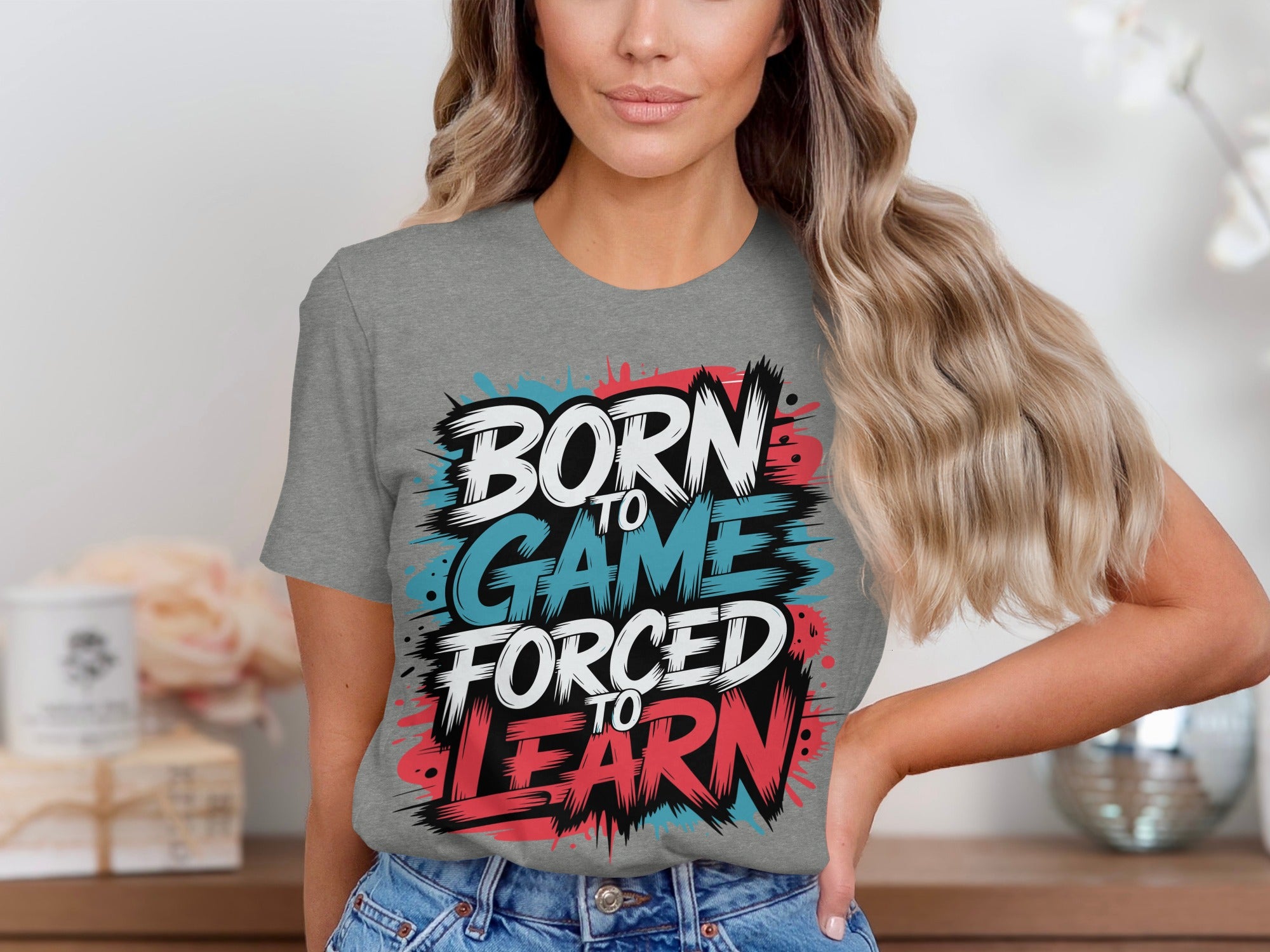 Gray t-shirt with text "BORN TO GAME FORCED TO LEARN" in colorful distressed font.