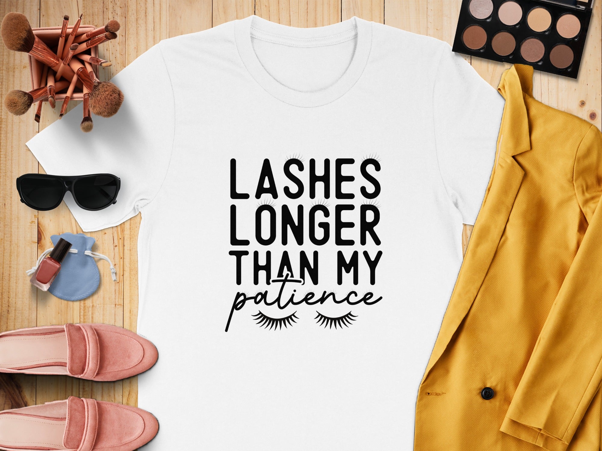 White t-shirt with black text reading "Lashes longer than my patience" and lash graphics.