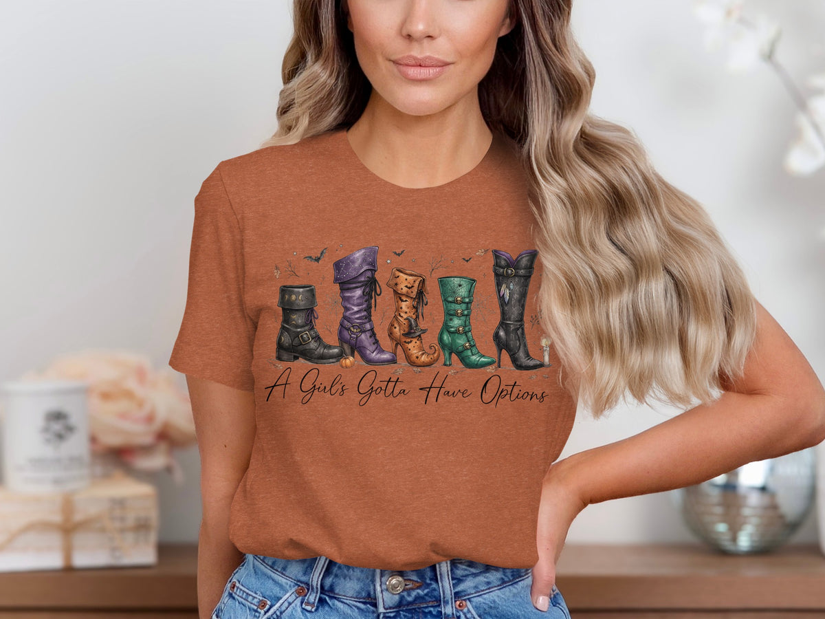 T-shirt with graphic of witch boots and text "A Girl's Gotta Have Options".