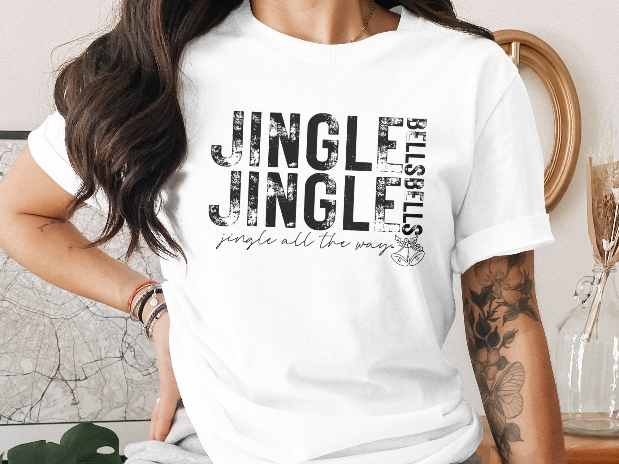 White t-shirt with "Jingle Jingle Bells Bells" text and holiday bells graphic.