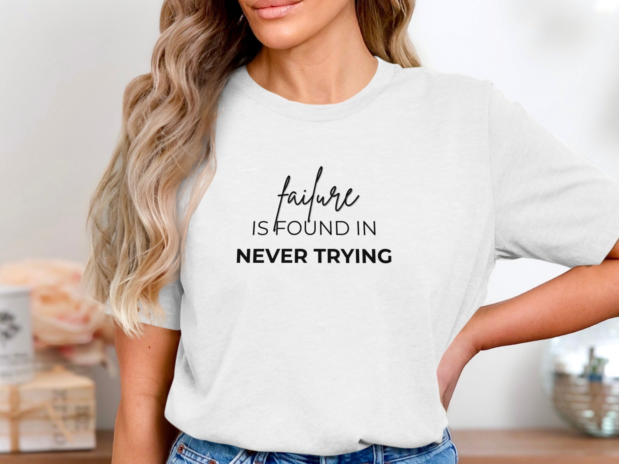 White t-shirt with the text "failure is found in never trying" in black font.