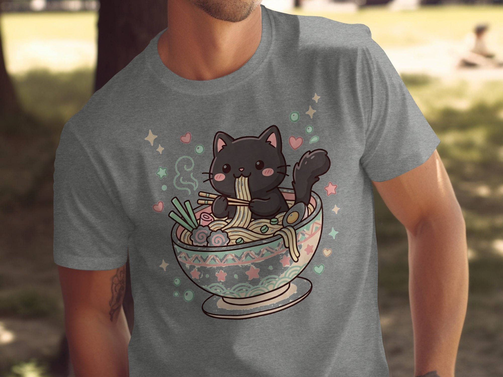 A black cat eats ramen noodles from a bowl decorated with abstract patterns and pastel shapes.