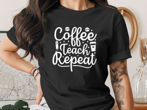 Black t-shirt with white text: Coffee Teach Repeat, pencil, and coffee cup.