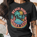 Black t-shirt with "Beach More Worry Less" text and island graphic.