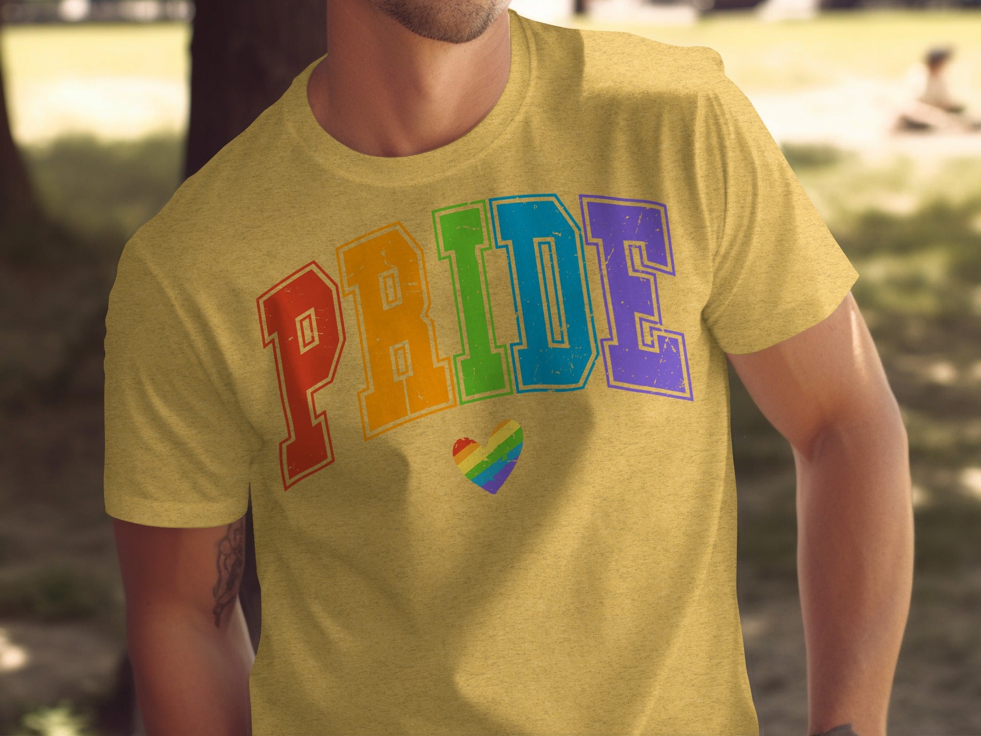 Yellow t-shirt with "PRIDE" text in rainbow colors and a rainbow heart.