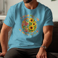 Blue t-shirt with a brain graphic split into patchwork fabric and sunflowers, text says "The sun will rise and we will try again".