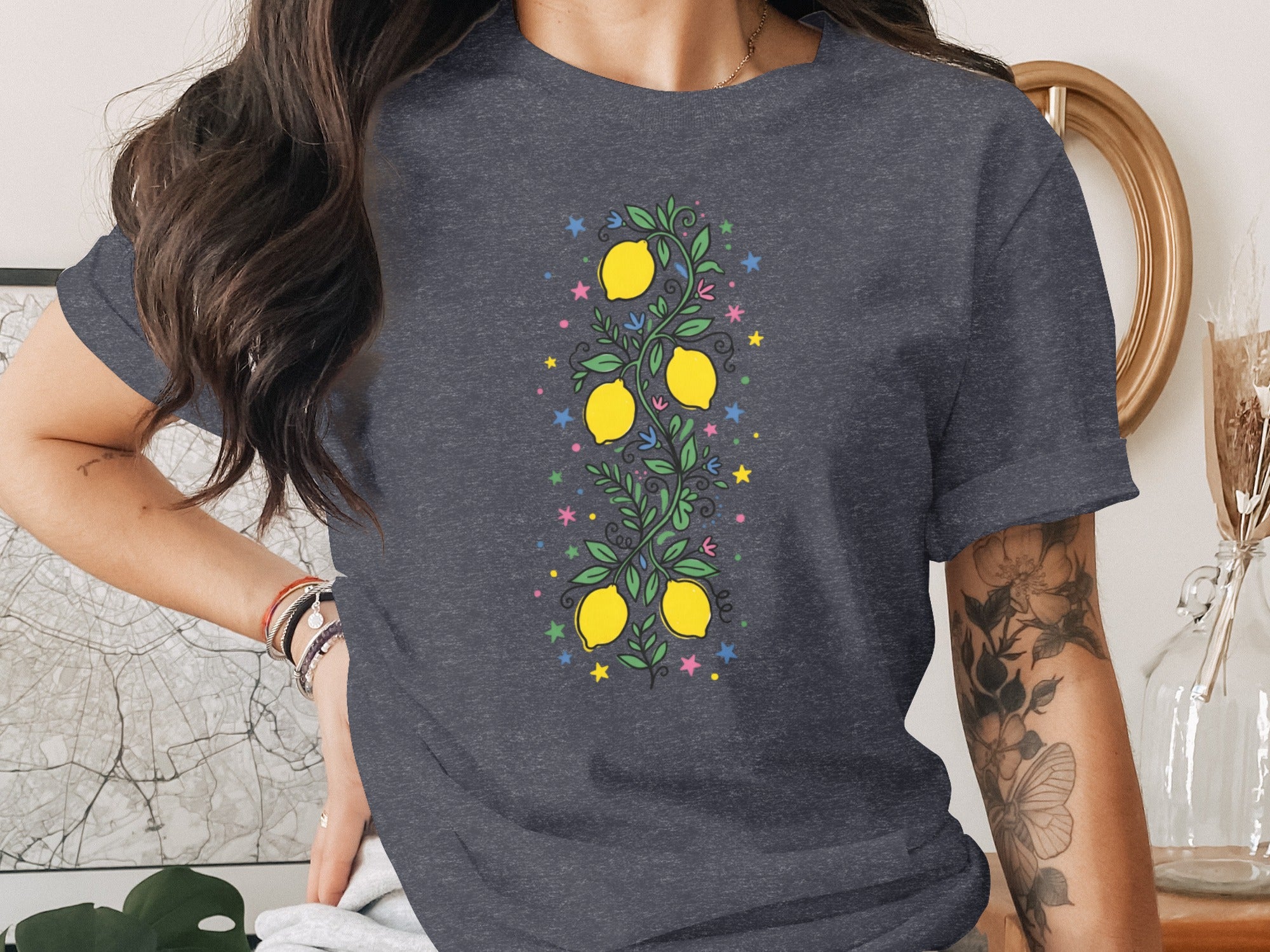 Dark grey t-shirt with a vertical illustration of lemons, leaves, and stars.