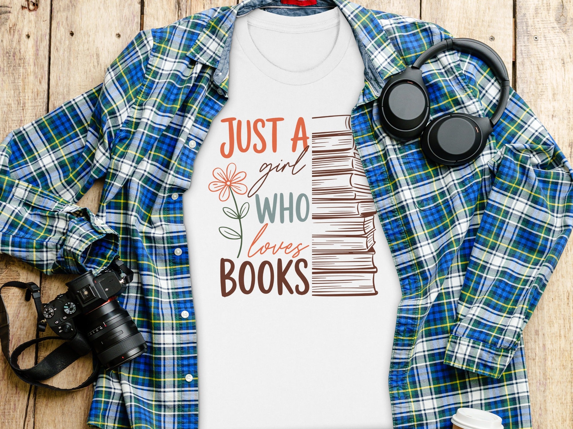 White t-shirt with "Just a girl who loves books" graphic and stack of books.