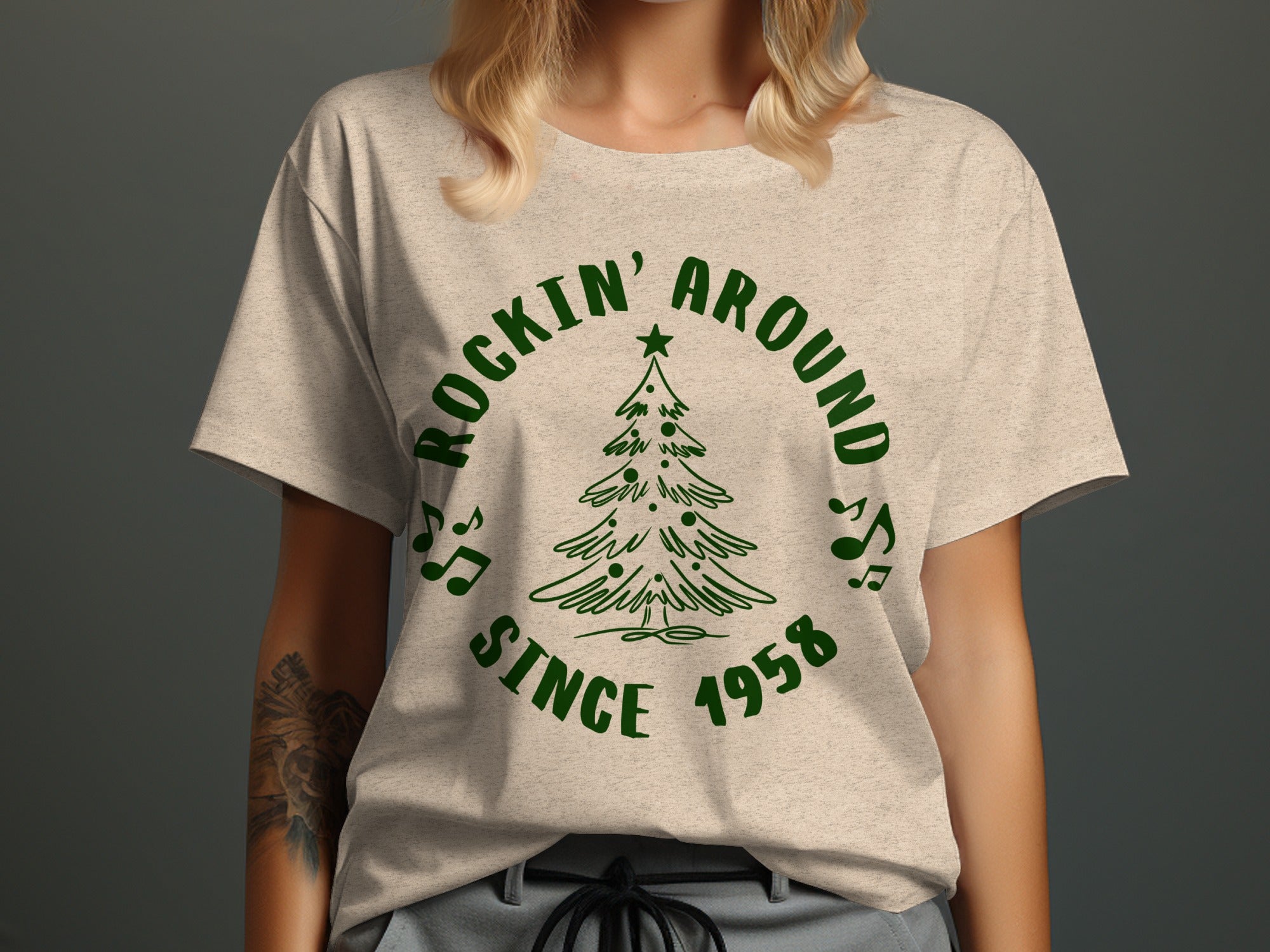 Light tan t-shirt with green graphic of a Christmas tree and text.