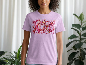 Purple t-shirt with pink "XOXO" graphic featuring bows and hearts.