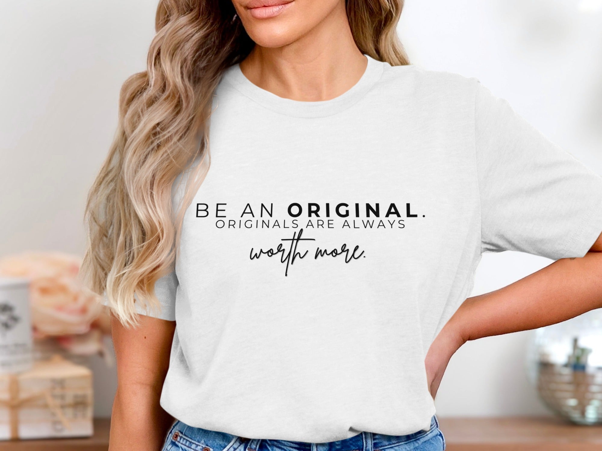 White t-shirt with black text "BE AN ORIGINAL. ORIGINALS ARE ALWAYS worth more."