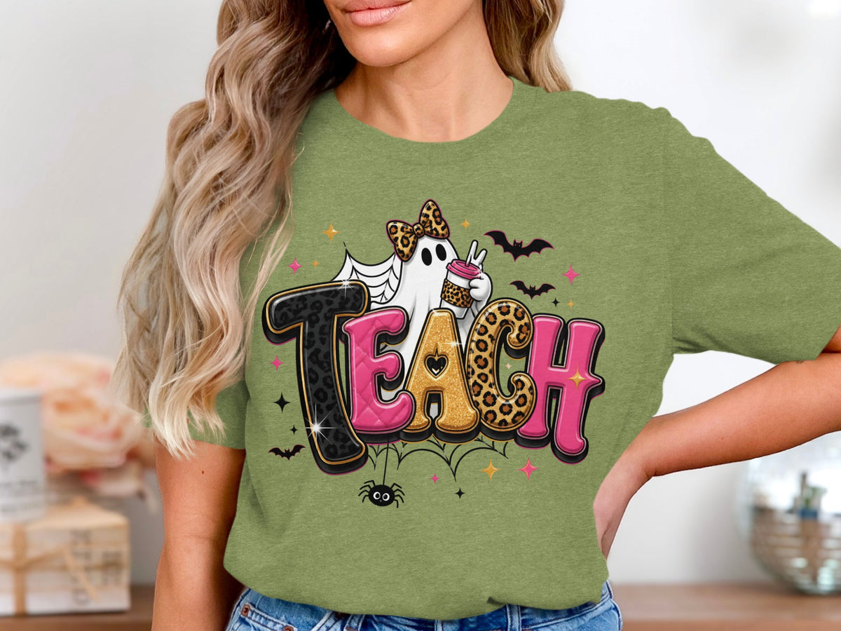 Green t-shirt with "TEACH" text featuring a ghost and Halloween graphics.