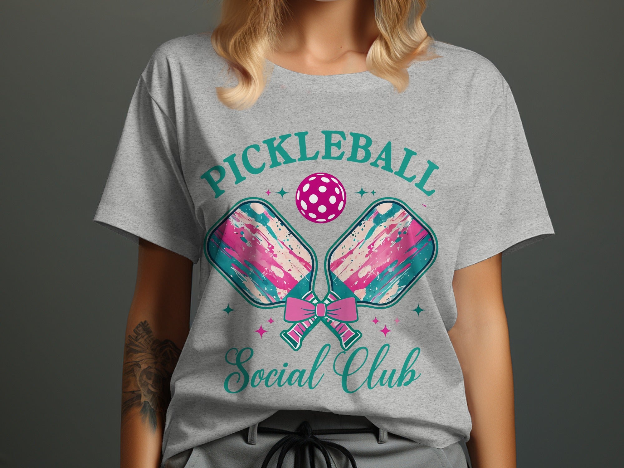 Grey t-shirt with "Pickleball Social Club" text, paddles, and ball.