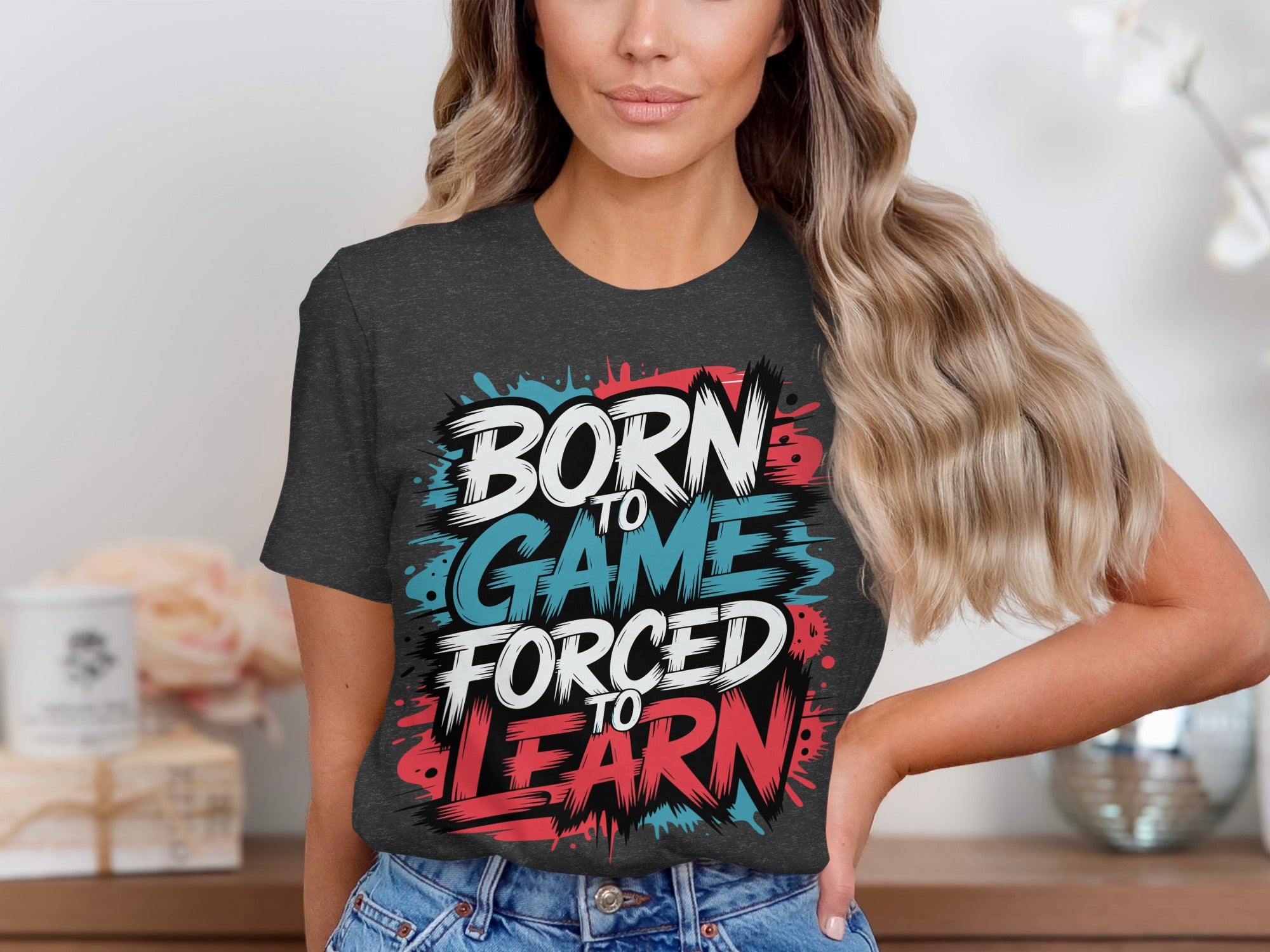 Dark grey t-shirt with "Born to Game Forced to Learn" graphic in white, blue, and red.