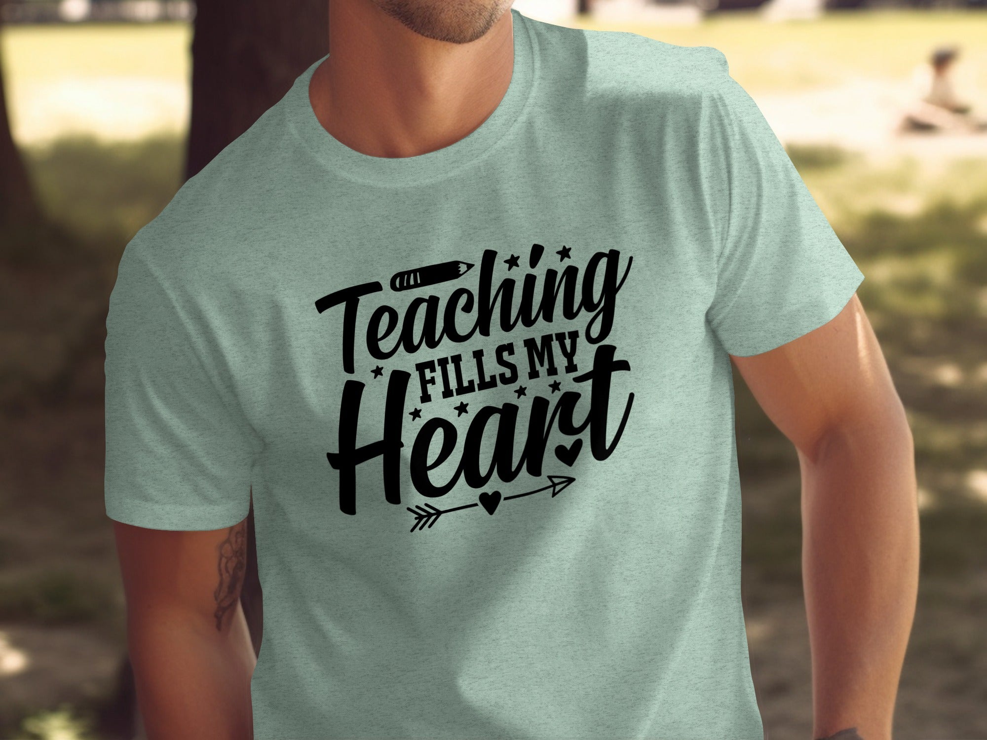 Light grey t-shirt with black text reading "Teaching Fills My Heart."