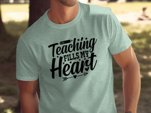 Light grey t-shirt with black text reading "Teaching Fills My Heart."