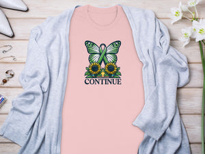 Light pink t-shirt with butterfly, sunflowers, and the word "CONTINUE".