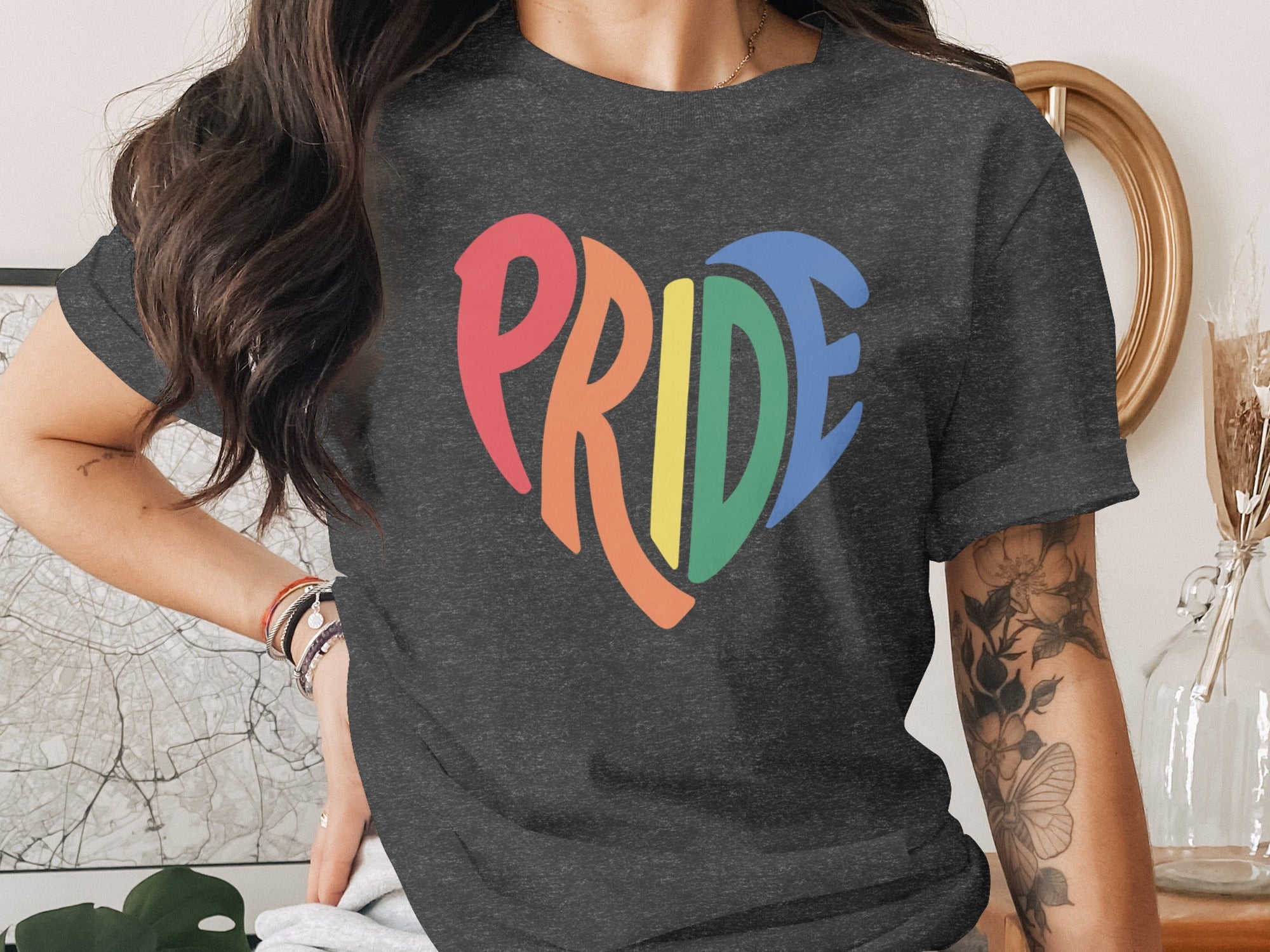 Dark gray t-shirt with rainbow heart graphic spelling "PRIDE".