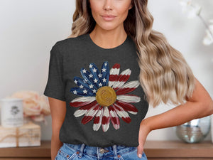 Girl wearing dark t-shirt with American flag daisy graphic.