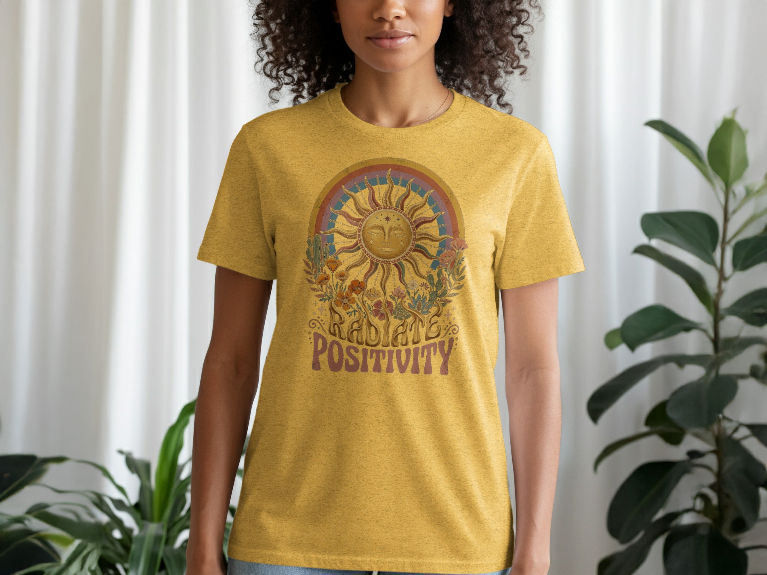 Yellow t-shirt with sun, flowers, and text that reads "RADIATE POSITIVITY".