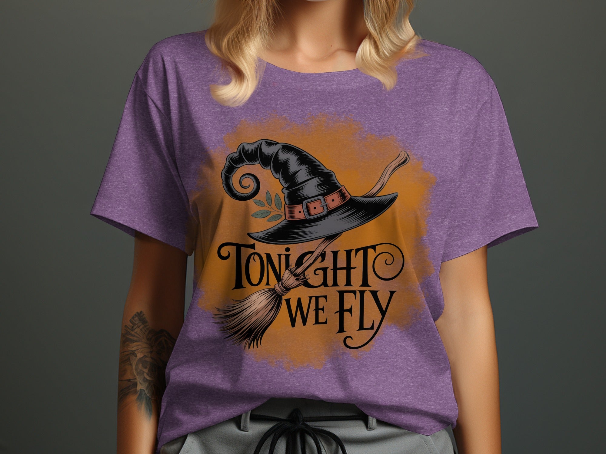 Purple t-shirt with witch hat, broom, and text "Tonight We Fly."