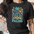 Black t-shirt with colorful tropical graphic and text "FIND ME UNDER THE PALMS".