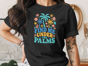 Black t-shirt with colorful tropical graphic and text "FIND ME UNDER THE PALMS".