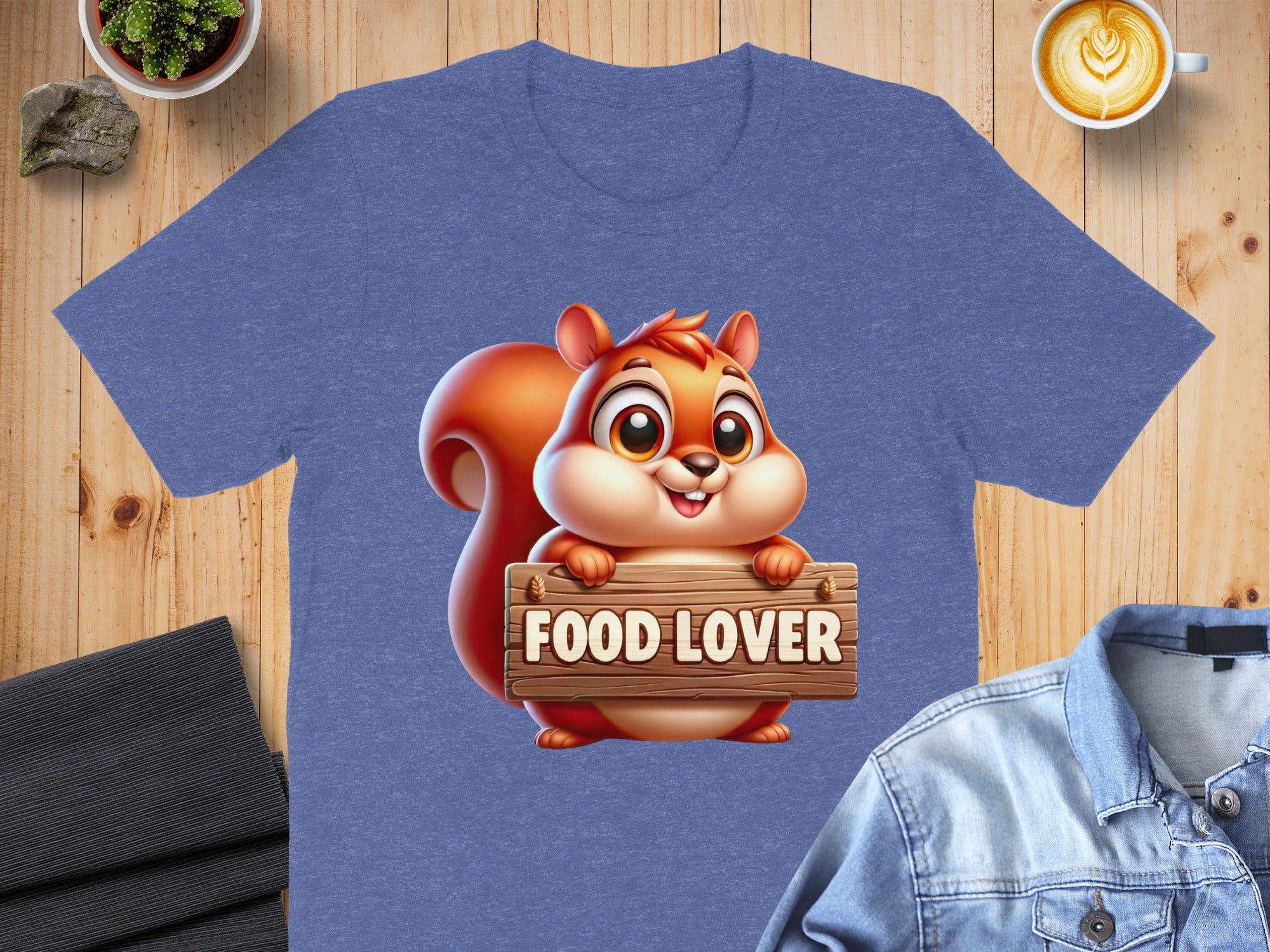 Cartoon squirrel holding a "FOOD LOVER" sign on a heather blue t-shirt.