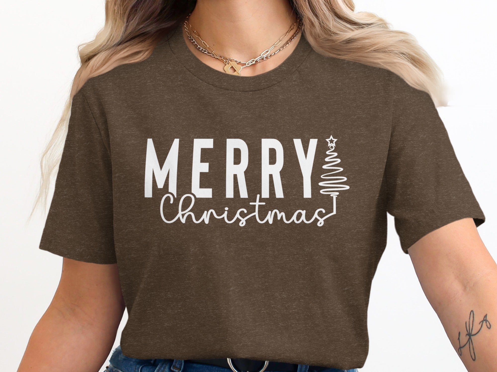 Brown t-shirt with "Merry Christmas" text and stylized Christmas tree.