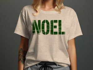 Light gray t-shirt with distressed green "NOEL" text across the chest.