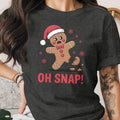 Gingerbread man in Santa hat with "OH SNAP!" text and broken leg.