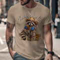 T-shirt graphic of a raccoon wearing a cowboy hat and holding a drink.