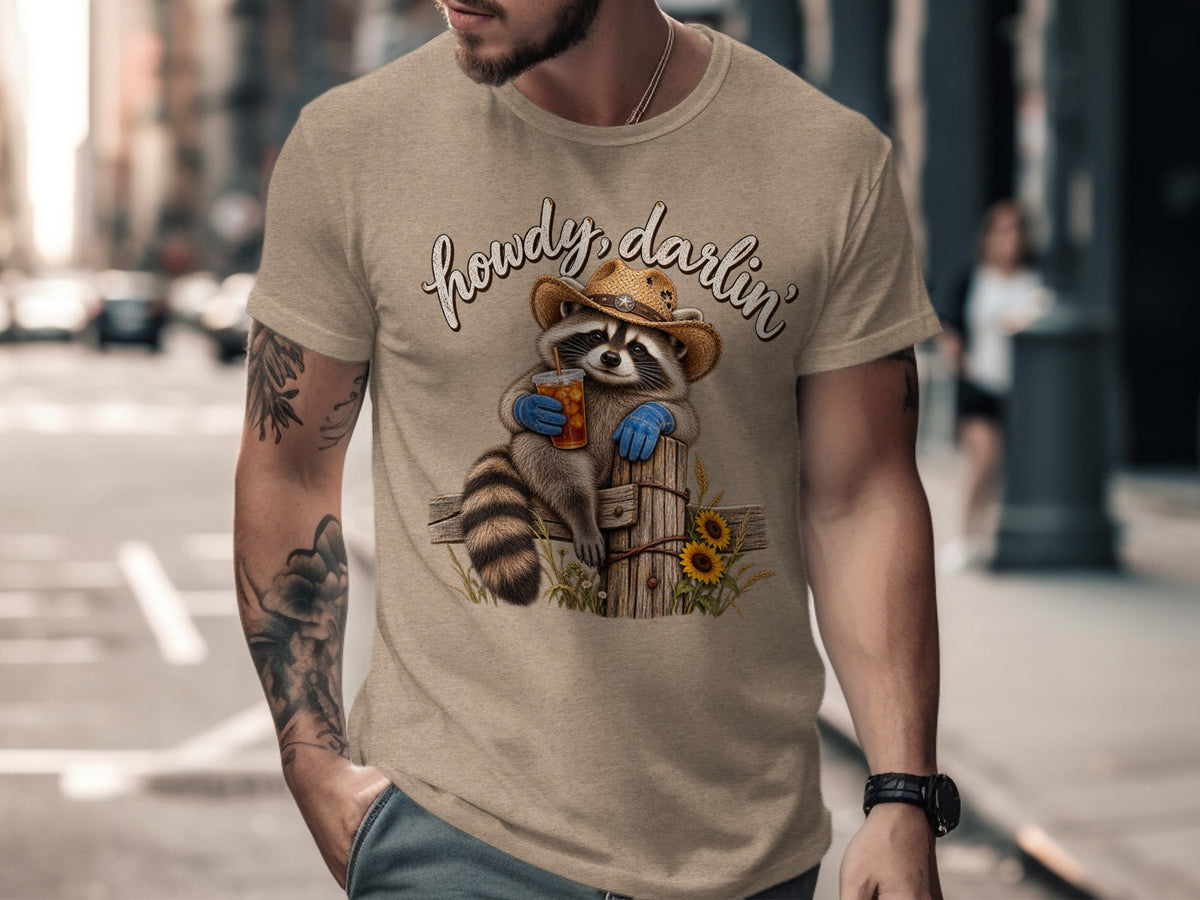 T-shirt graphic of a raccoon wearing a cowboy hat and holding a drink.