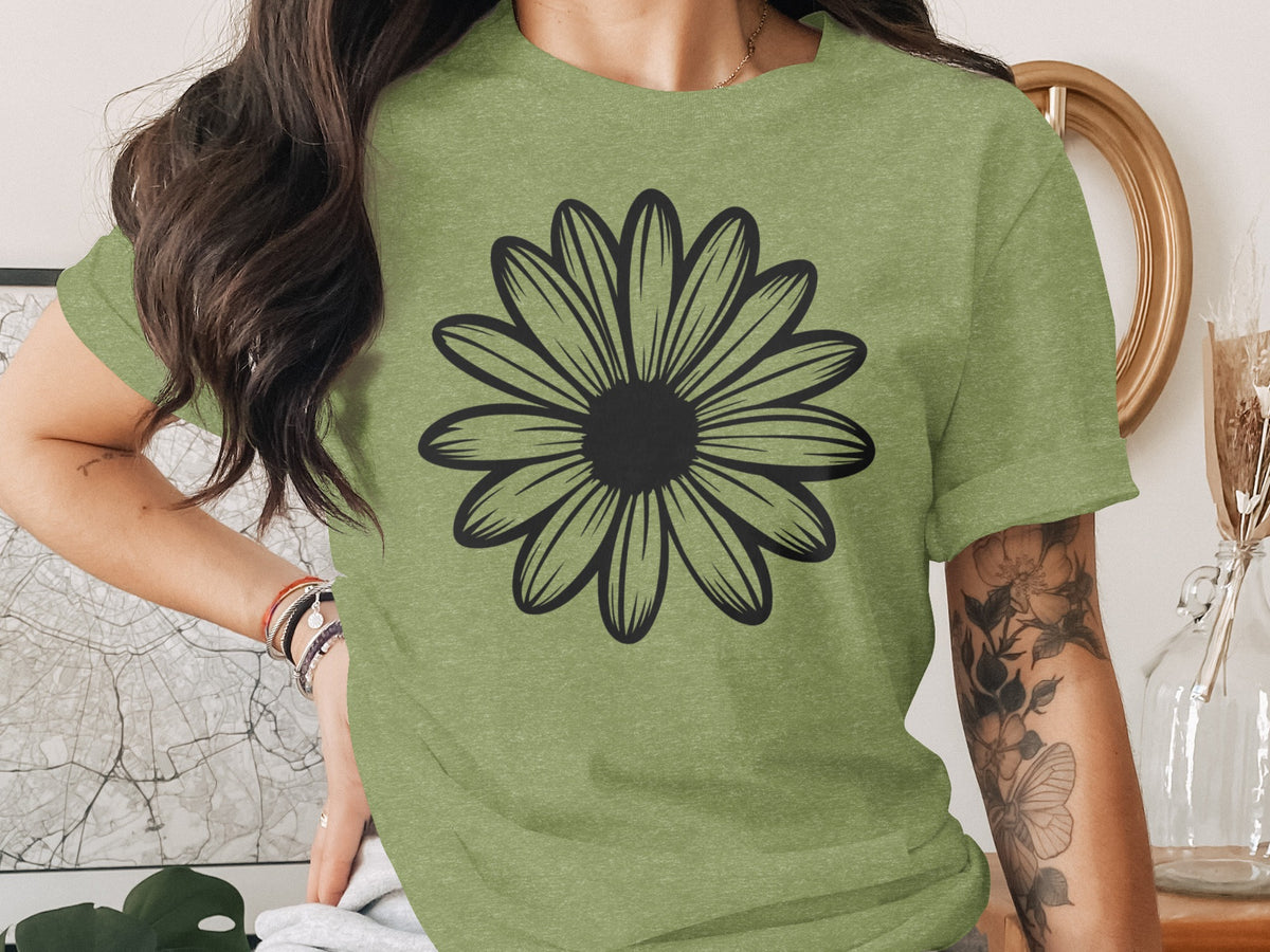 Green t-shirt with a black outline of a daisy on the front.