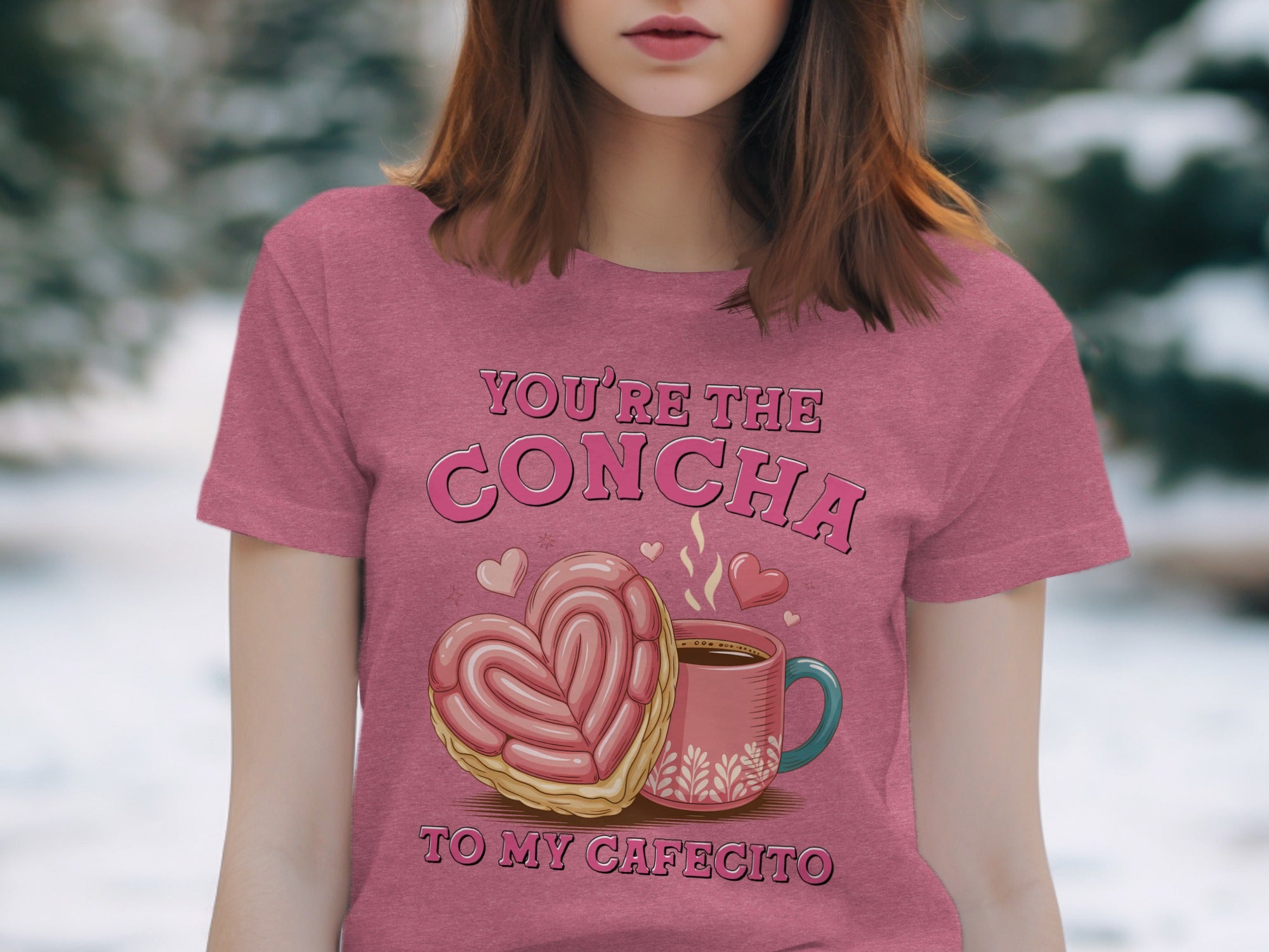 Pink t-shirt with graphic of heart-shaped concha, coffee cup, and text "You're the Concha to my Cafecito".
