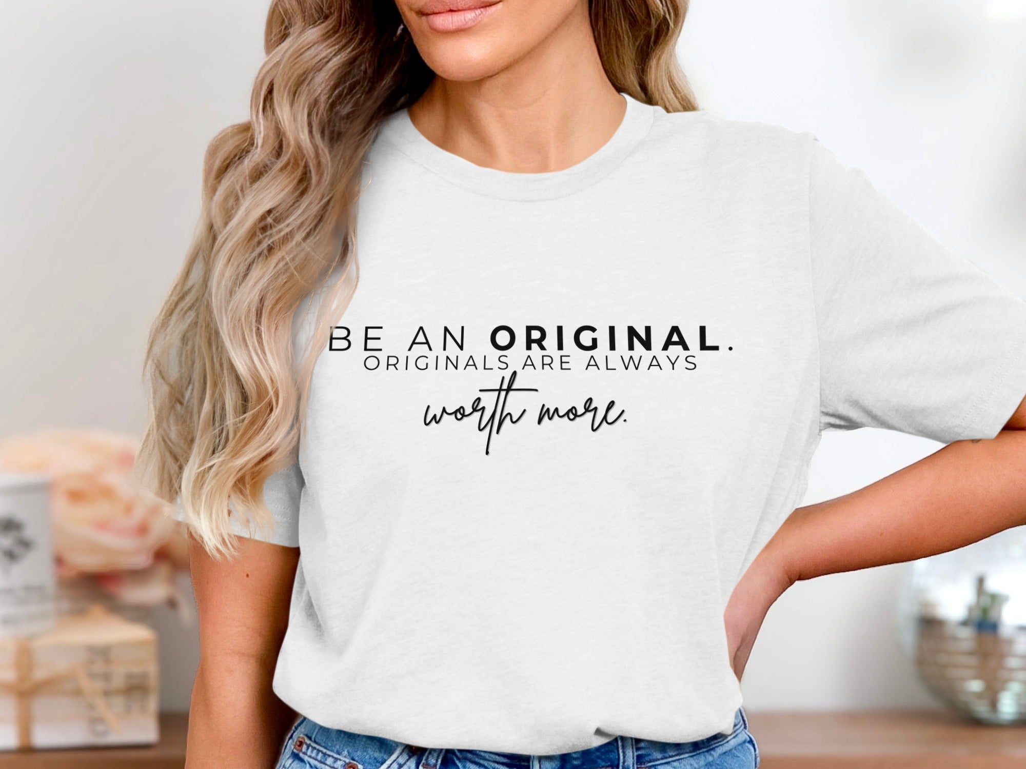 White t-shirt with black text "BE AN ORIGINAL. ORIGINALS ARE ALWAYS worth more."