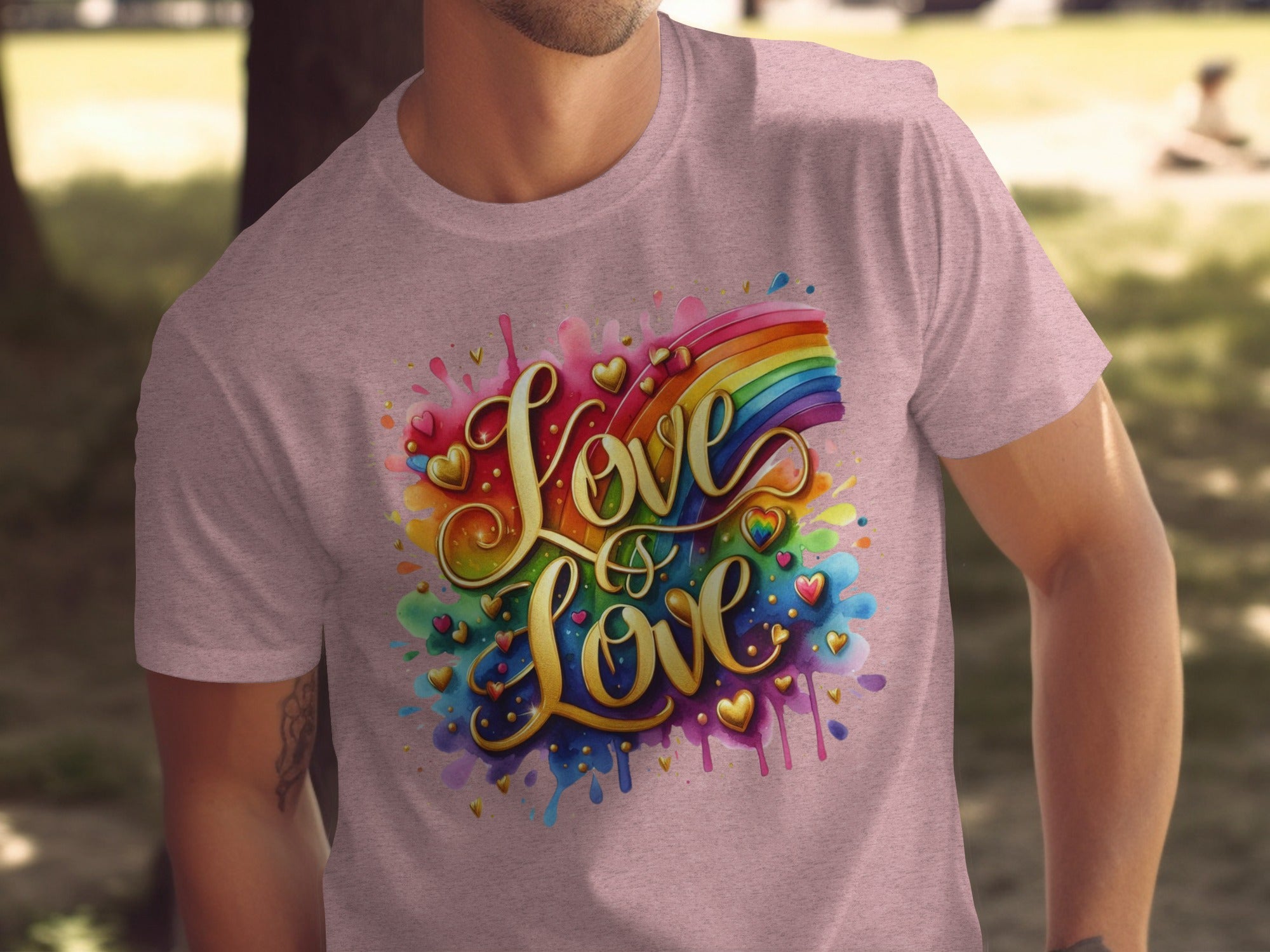 Pink t-shirt with gold text "Love is Love" and rainbow watercolor hearts.