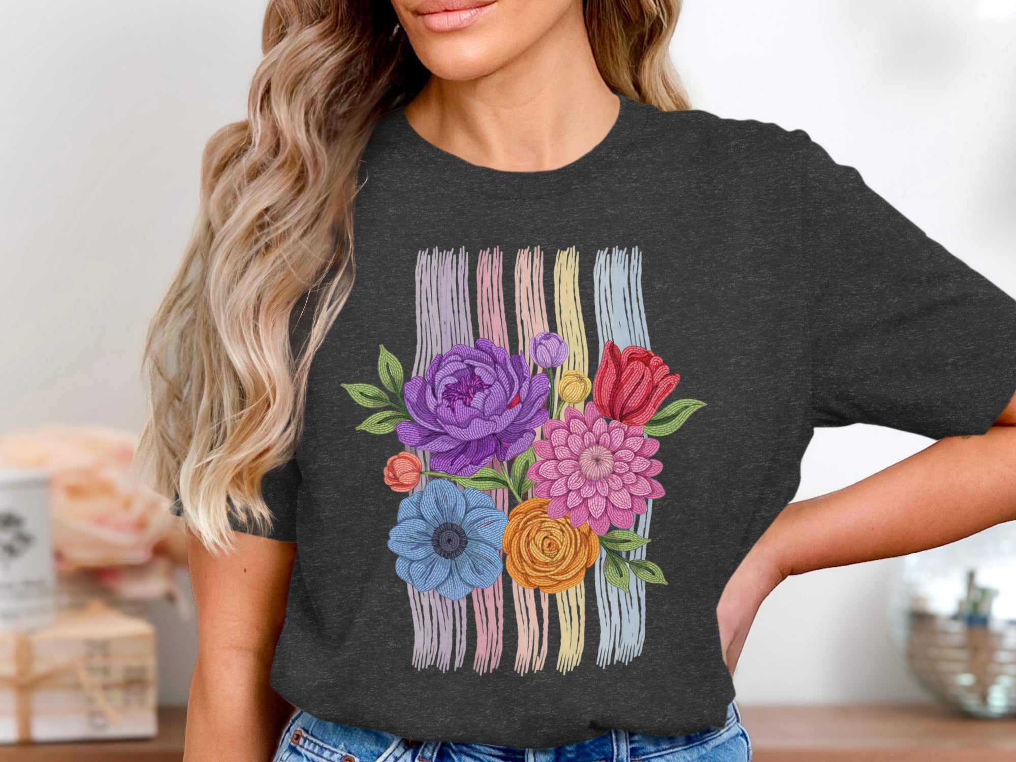 Dark t-shirt with a colorful floral bouquet design over pastel vertical stripes.