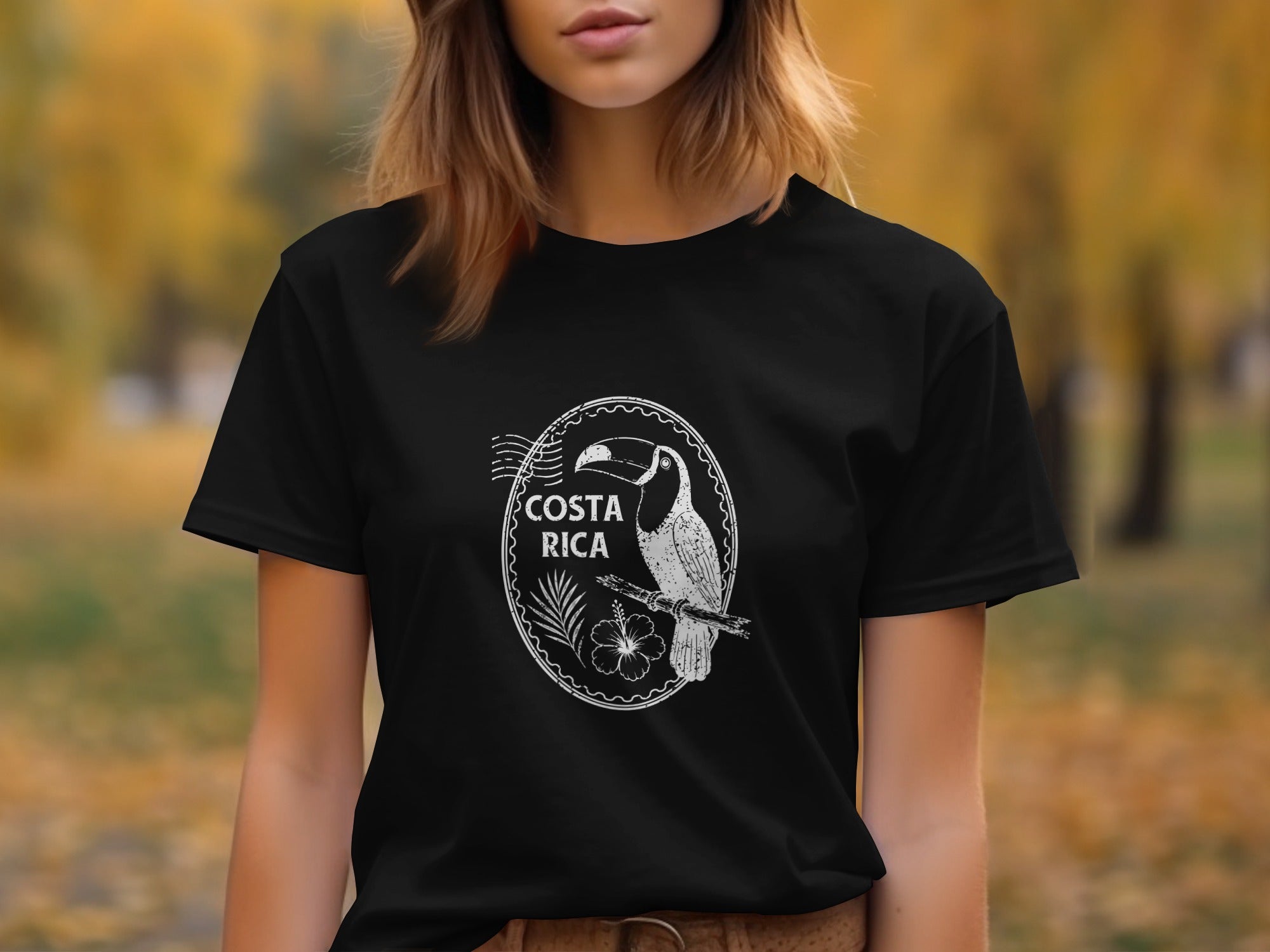 Black t-shirt with white Costa Rica toucan and hibiscus design on chest.